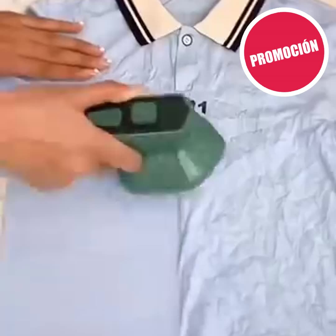 Mano pasando la mini plancha a vapor por una polo